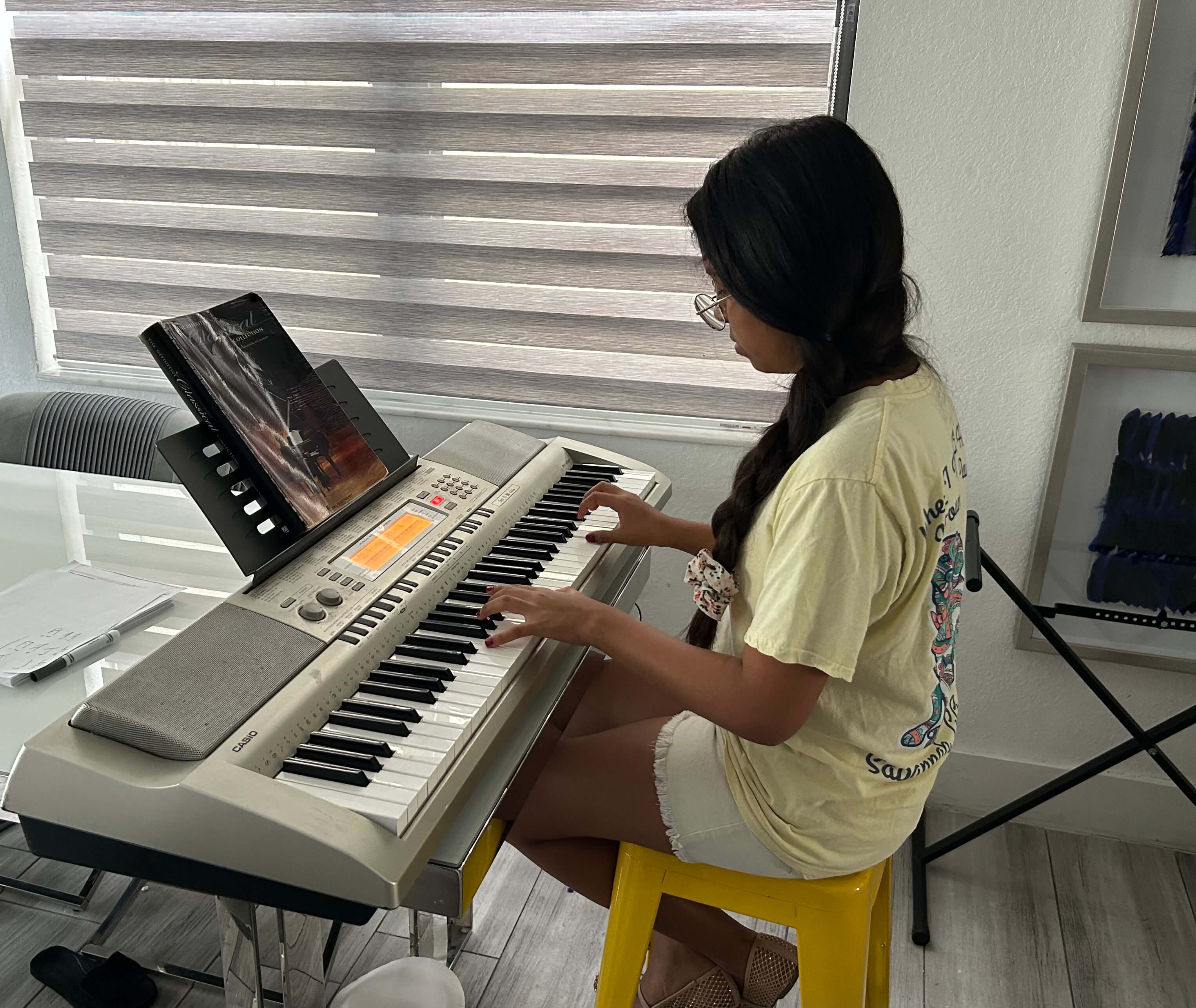 Ex Corde Academy student playing the piano